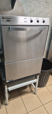 a stainless steel dishwasher and a trash can in a kitchen