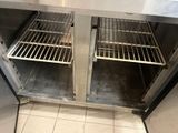 two open shelves in the middle of a stainless steel oven
