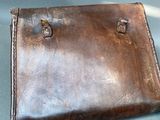a brown leather case sitting on top of a blue table