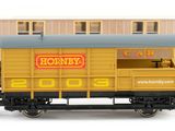 a yellow train car with a sign on the side of it