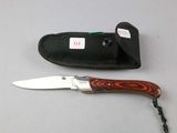 a knife that is laying next to a knife case