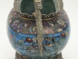 a decorative vase with a bird on top of it