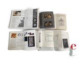 a lot of books that are open on a white surface