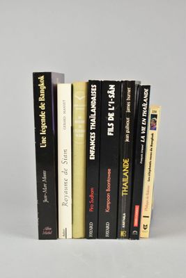 several books are stacked on top of each other on a white surface