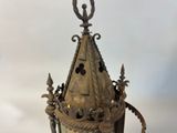 a large metal lantern with a dragon on the top of it