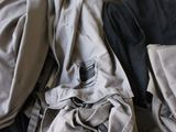 a pile of clothes sitting on a table in a room