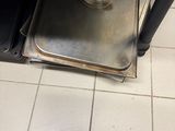 a metal tray sitting on top of a stove in a kitchen