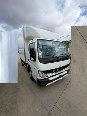 a white truck that is parked next to a building