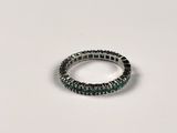 a close up of a ring on a table with a white background