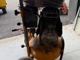 an image of a small air compressor in a garage