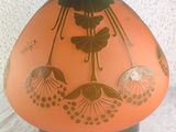 a vase with a design on it sitting on a table