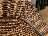 a wicker chair that is sitting on the floor