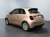 the small car is parked in the empty room of the building