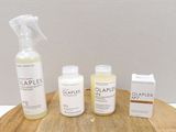 a bottle of olaplex and two bottles of olaplex on a cutting board