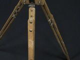 a wooden tripod on a black background with a black background