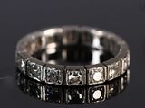 a close up of a diamond ring on a black surface