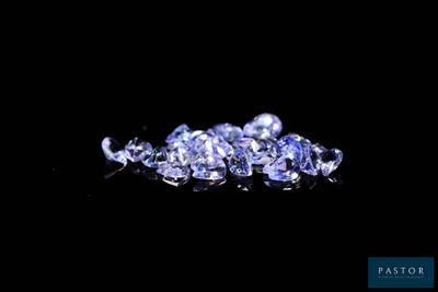 a close up of a bunch of blue sapphires on a black surface