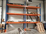 a room with a lot of shelves and pallets in it