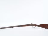 a rifle with a wooden barrel and a wooden handle