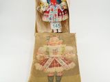 an image of a doll in a box on a white surface