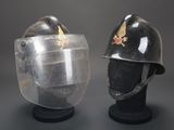 pair of helmets with a clear face shield and a red star on the side