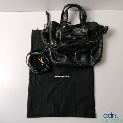 a black purse and a black bag on a white table