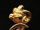 an image of a close up of a gold ring with a ram head on it