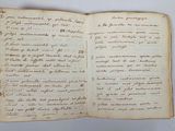 an old book with writing on it sitting on top of a table