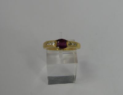 an image of a gold ring with a ruby stone on it