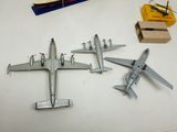 four model airplanes sitting on a table next to a box