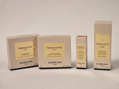 three boxes of cosmetics are sitting next to each other on a white surface