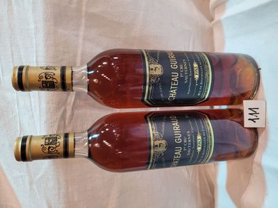 two bottles of wine sitting next to each other on top of a table