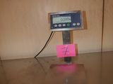 an image of a scale on a table with a note attached to it
