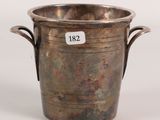 an antique silver plated wine bucket with handles on a white background