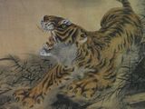 painting of a tiger leaping over a tree branch in a gold frame