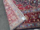 a rug on the ground next to a pair of shoes