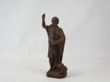 an old wooden statue of a man holding a bird on a white background