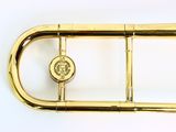 a brass instrument that is sitting on a white surface