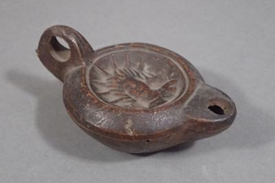 Lampe à huile en terre cuite à décor du Dieu Soleil (long.