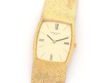 an image of a gold wrist watch with roman numerals on it