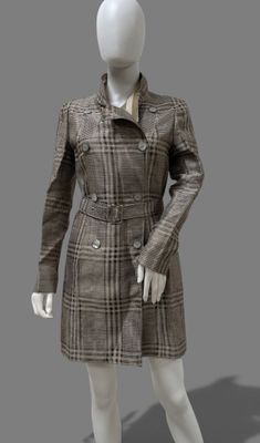 female mannequin dressed in a brown plaid coat and skirt