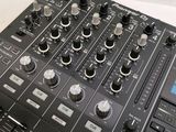 a close up of a dj mixer with buttons and knobs