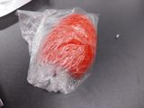 a red ball of yarn on a black table