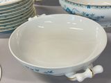 a lot of plates and bowls on the table