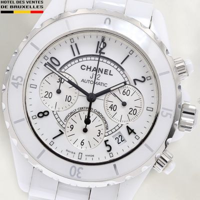 a close up of a watch with a white face