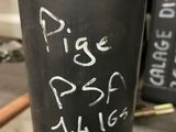 a black cup with writing on it sitting on a table