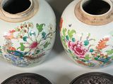 two vases sitting next to each other on a table
