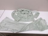 two pieces of clothing on a table next to each other