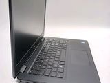 a laptop that is open on a white surface