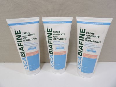 three tubes of toothpaste sitting on top of a white counter